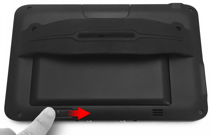 This figure depicts sliding the battery latch on the rear of the tablet. This figure depicts sliding the battery latch on the rear of the tablet.